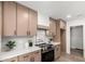 Modern kitchen with updated appliances, tile backsplash, bright countertops, and plenty of cabinet storage at 7467 E Pleasant Run, Scottsdale, AZ 85258