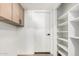 Walk-in pantry with storage solutions and custom shelving at 7467 E Pleasant Run, Scottsdale, AZ 85258
