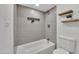 Clean bathroom with a tub and shower combination, neutral tile, and contemporary fixtures at 7826 N 21St Ln, Phoenix, AZ 85021
