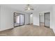 Bright bedroom with a sliding glass door to patio and mirrored closet door, with wood-look floors at 7826 N 21St Ln, Phoenix, AZ 85021