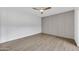 Spacious bedroom with modern wall paneling and light, wood-look flooring creating a serene retreat at 7826 N 21St Ln, Phoenix, AZ 85021