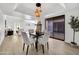 Bright dining area with stylish light fixture, modern table and chairs, and sliding glass door at 7826 N 21St Ln, Phoenix, AZ 85021