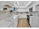 Modern kitchen featuring stainless steel appliances, sleek white cabinets, and stylish floating shelves at 7826 N 21St Ln, Phoenix, AZ 85021
