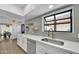 Modern kitchen boasting stainless appliances, white cabinets, quartz countertops, and trendy hardware at 7826 N 21St Ln, Phoenix, AZ 85021