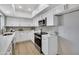 Well-lit kitchen boasting stainless steel appliances, ample white cabinetry, and sleek countertops at 7826 N 21St Ln, Phoenix, AZ 85021