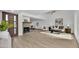 Open-concept living area featuring wood floors, a brick fireplace, and abundant natural light at 7826 N 21St Ln, Phoenix, AZ 85021