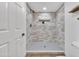 Modern tiled shower featuring neutral-tone tiles, a rainfall showerhead, and a built-in niche at 7826 N 21St Ln, Phoenix, AZ 85021