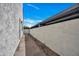 Side walkway featuring neutral stucco walls with desert landscaping and a covered area at 7826 N 21St Ln, Phoenix, AZ 85021