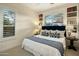 Bright bedroom with a blue headboard, built-in bookshelves, and natural light at 7979 E Princess Dr # 26, Scottsdale, AZ 85255