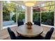 Cozy dining area featuring a round table and large windows offering views of the lush outdoor landscaping at 7979 E Princess Dr # 26, Scottsdale, AZ 85255