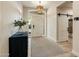 Bright entryway with a textured front door, barn door, and wooden flooring at 7979 E Princess Dr # 26, Scottsdale, AZ 85255