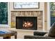 Close up of the living room fireplace with brick surround and a gas fire at 7979 E Princess Dr # 26, Scottsdale, AZ 85255