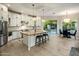 Spacious kitchen with white cabinetry, central island with seating, and stainless steel appliances at 7979 E Princess Dr # 26, Scottsdale, AZ 85255