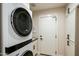 Laundry room with stackable washer/dryer unit, cabinets and utility sink at 7979 E Princess Dr # 26, Scottsdale, AZ 85255