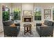Cozy living room with a brick fireplace, large windows, and comfortable seating at 7979 E Princess Dr # 26, Scottsdale, AZ 85255