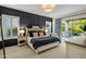 Comfortable main bedroom with elegant wall paneling and private access to the outdoor living area at 7979 E Princess Dr # 26, Scottsdale, AZ 85255