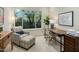 Well-lit home office with comfortable seating and a large window overlooking the backyard at 7979 E Princess Dr # 26, Scottsdale, AZ 85255