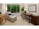 Bright office with large window, striped chair with ottoman, wooden desk, and serene decor at 7979 E Princess Dr # 26, Scottsdale, AZ 85255