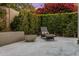 Secluded backyard area featuring a tranquil water feature, comfortable chaise lounge, and lush landscaping at 7979 E Princess Dr # 26, Scottsdale, AZ 85255