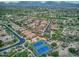 Wide aerial shot showcasing community tennis courts, mountains, a green golf course, and rows of houses at 8235 E Sierra Pinta Dr, Scottsdale, AZ 85255