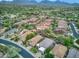 Expansive high-angle shot displaying the neighborhood's well-kept lawns, rooftops, and community layout at 8235 E Sierra Pinta Dr, Scottsdale, AZ 85255
