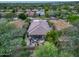 Expansive aerial view of the home showcasing the roof, backyard patio set, and surrounding landscaping at 8235 E Sierra Pinta Dr, Scottsdale, AZ 85255