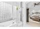 View from bathroom offers a glass-door shower, soaking tub, and view into bedroom at 8235 E Sierra Pinta Dr, Scottsdale, AZ 85255