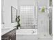 Bright bathroom features a soaking tub, glass block window, and glass enclosed shower with white marble style tile at 8235 E Sierra Pinta Dr, Scottsdale, AZ 85255