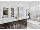This bathroom features a double sink vanity and a soaking tub at 8235 E Sierra Pinta Dr, Scottsdale, AZ 85255