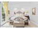 The bright bedroom features an ornate metal bed frame and a patio exit at 8235 E Sierra Pinta Dr, Scottsdale, AZ 85255