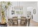 Elegant dining room featuring an ornate chandelier and views of the outdoors at 8235 E Sierra Pinta Dr, Scottsdale, AZ 85255