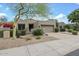 Charming single-story home with desert landscaping and a two-car garage at 8235 E Sierra Pinta Dr, Scottsdale, AZ 85255
