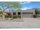 Charming single-story home with desert landscaping and a two-car garage at 8235 E Sierra Pinta Dr, Scottsdale, AZ 85255