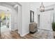Bright and airy foyer featuring tile floors, high ceilings, and modern chandelier at 8235 E Sierra Pinta Dr, Scottsdale, AZ 85255