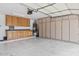 Spacious garage features built in cabinets and workbench area, providing ample storage and workspace at 8235 E Sierra Pinta Dr, Scottsdale, AZ 85255