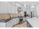 Modern kitchen with white cabinets, stainless steel appliances, and a stylish backsplash at 8235 E Sierra Pinta Dr, Scottsdale, AZ 85255