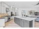 Modern kitchen with white cabinets, stainless steel appliances, and a gray center island at 8235 E Sierra Pinta Dr, Scottsdale, AZ 85255