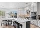 Spacious kitchen featuring a large island with seating and stainless steel appliances at 8235 E Sierra Pinta Dr, Scottsdale, AZ 85255