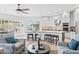 Stylish living room seamlessly connected to a modern kitchen with a large island and stools at 8235 E Sierra Pinta Dr, Scottsdale, AZ 85255