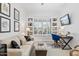 Bright room with sofa and desk and chair and a bank of windows with white shutters for privacy and light control at 8235 E Sierra Pinta Dr, Scottsdale, AZ 85255