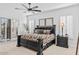This main bedroom features a ceiling fan and an elegant dark-wood bedroom set at 8235 E Sierra Pinta Dr, Scottsdale, AZ 85255