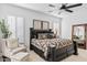 This main bedroom features a ceiling fan and an elegant dark-wood bedroom set at 8235 E Sierra Pinta Dr, Scottsdale, AZ 85255