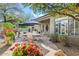 Inviting patio with stone pavers, elegant outdoor dining set, and landscaping at 8235 E Sierra Pinta Dr, Scottsdale, AZ 85255