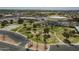Aerial view of a community park with walking paths, playgrounds, a basketball court and mature palm trees at 945 N Pasadena -- # 84, Mesa, AZ 85201