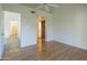 Inviting bedroom features wood floors, a ceiling fan, and access to hallway, closet, and en-suite bathroom at 945 N Pasadena -- # 84, Mesa, AZ 85201