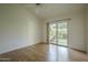 Light-filled bedroom boasts wood-look floors and sliding glass door access to the private backyard at 945 N Pasadena -- # 84, Mesa, AZ 85201