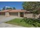 Charming home featuring a terra cotta roof, a two-car garage, and a well-maintained front lawn at 945 N Pasadena -- # 84, Mesa, AZ 85201