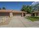 Charming home featuring a terra cotta roof, a two-car garage, and a well-maintained front lawn at 945 N Pasadena -- # 84, Mesa, AZ 85201