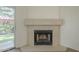 Close up of the fireplace with view of the backyard with colorful plants at 945 N Pasadena -- # 84, Mesa, AZ 85201
