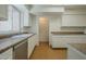 Well-lit kitchen with white cabinets, countertops, and stainless steel appliances at 945 N Pasadena -- # 84, Mesa, AZ 85201